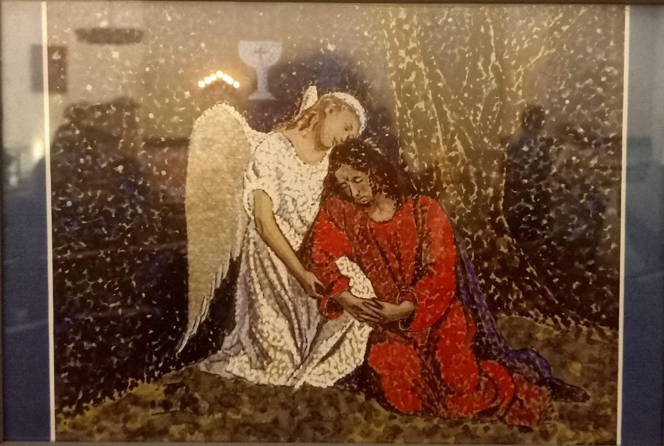 Kuvassa puna-asuinen Jeesus itkee ja rukoilee Getsemanessa ja häntä lohduttaa valkoasuinen enkeli.