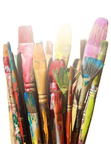 Kuvassa näkyy taiteilijoiden pensseleitä lasipurkissa.
